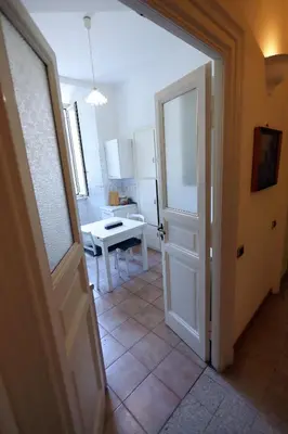 an open door to a kitchen with a table at Casa Salimei in Rome