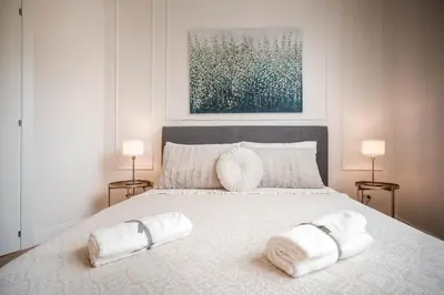 a bedroom with a large white bed with towels on it at Appartamento San Giovanni fino a 6 persone in Rome