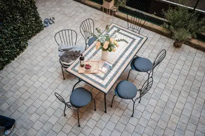 an overhead view of a table and chairs with a cat on it at Appartamento San Giovanni fino a 6 persone in Rome