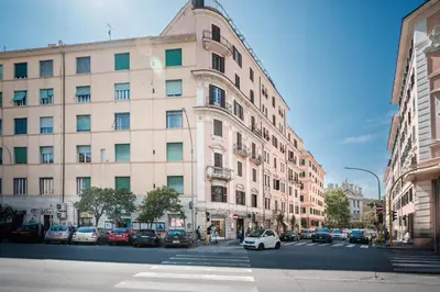 a white car parked in front of a large building at Appartamento San Giovanni fino a 6 persone in Rome