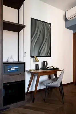 a kitchen with a wooden table and a chair at Boutique Hotel Piedra Rome City Centre in Rome