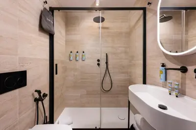 a bathroom with a shower and a toilet and a sink at Boutique Hotel Piedra Rome City Centre in Rome