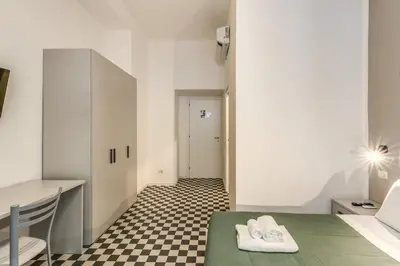 a room with a green table and a checkered floor at Orazio's Charming Apartment in Rome
