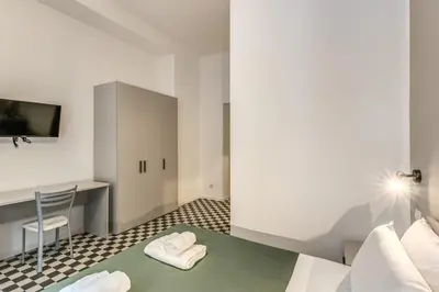 a hotel room with a bed and a desk at Orazio's Charming Apartment in Rome