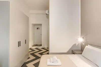 a room with a bed with two towels on it at Orazio's Charming Apartment in Rome