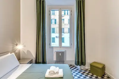 a bedroom with a bed with two towels on it at Orazio's Charming Apartment in Rome