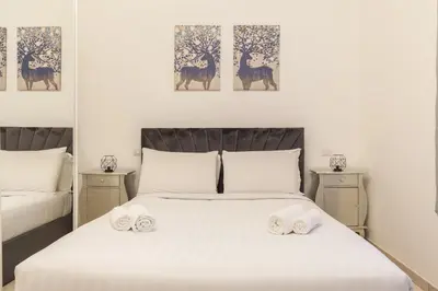 a bedroom with a large white bed with towels on it at Hostly-Michelangelo Cloister Suite-Center of Rome in Rome