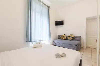 a bedroom with a large bed and a couch at Hostly-Michelangelo Cloister Suite-Center of Rome in Rome