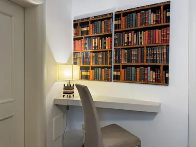 a library with a desk and a chair and a lamp at Banchi Vecchi Stay Apt Suite Pantheon in Rome
