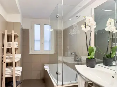 a bathroom with a glass shower and a sink at Banchi Vecchi Stay Apt Suite Pantheon in Rome