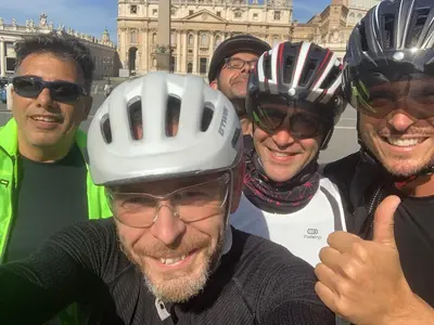 a group of men wearing helmets posing for a picture at A Den for Two in Rome