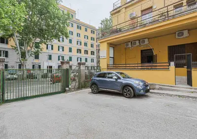 a small blue car parked in front of a building at Aquas Salvias in Rome