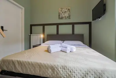 two rolls of towels sitting on top of a bed at Aquas Salvias in Rome