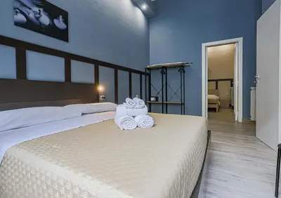 a bedroom with a bed with two towels on it at Aquas Salvias in Rome