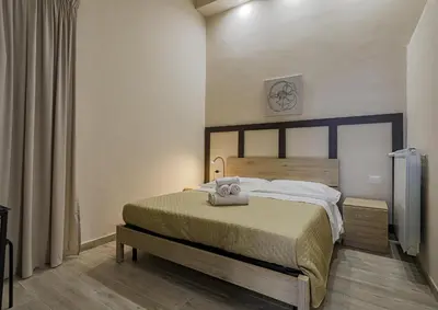 a bedroom with a large bed in a room at Aquas Salvias in Rome