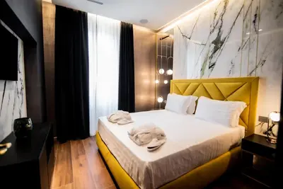 a hotel room with a bed with towels on it at Luxury Rhome Via della Croce in Rome