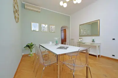 a dining room with a white table and chairs at YCH-Comfortable 2 bedrooms flat near Colosseum in Rome