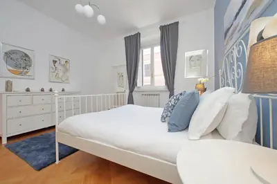 a bedroom with a large white bed and a window at YCH-Comfortable 2 bedrooms flat near Colosseum in Rome