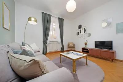 a living room with a couch and a table at YCH-Comfortable 2 bedrooms flat near Colosseum in Rome