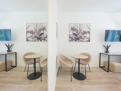 two tables and chairs in a room with paintings on the wall at White Ottaviano in Rome