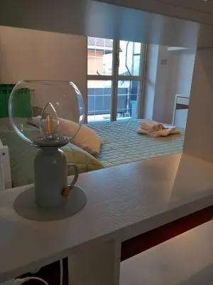 a room with a bed with a glass bowl on a table at La mia casetta a Porta Furba in Rome