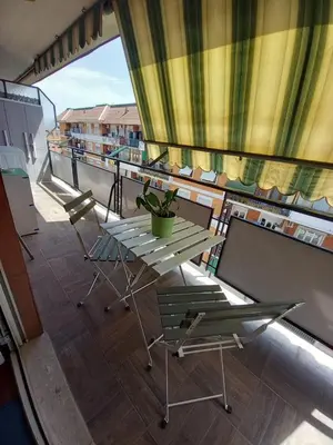 a balcony with a table and chairs on a ship at La mia casetta a Porta Furba in Rome
