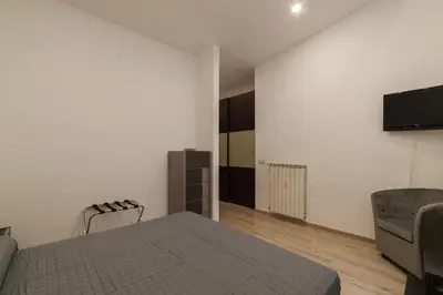 a bedroom with a bed and a tv on a wall at GuestHost - Trastevere Three Cozy Rooms in Rome
