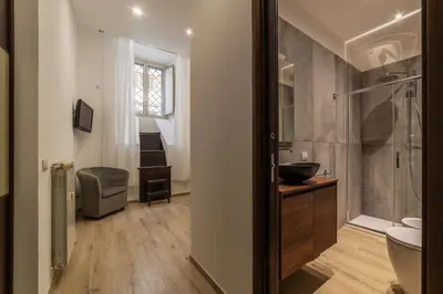 a bathroom with a sink and a toilet and a shower at GuestHost - Trastevere Three Cozy Rooms in Rome