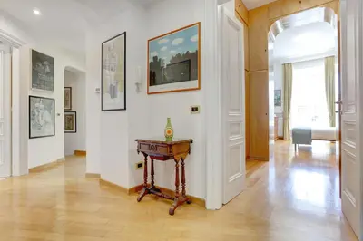 a hallway with a table in the middle of a room at Colosseo Family Art 3BDR - Home and More in Rome