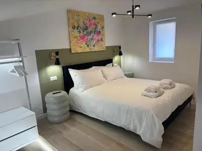 a bedroom with a bed and a painting on the wall at MauveSweetRhome 2 in Rome