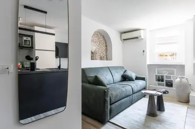 a living room and kitchen with a blue couch at MauveSweetRhome 2 in Rome
