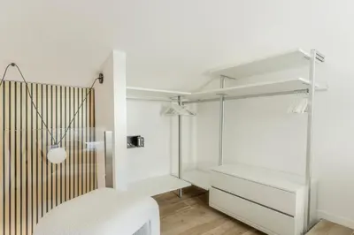 a white bedroom with white furniture and white walls at MauveSweetRhome 2 in Rome