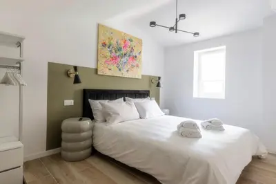 a bedroom with a large white bed with two towels on it at MauveSweetRhome 2 in Rome
