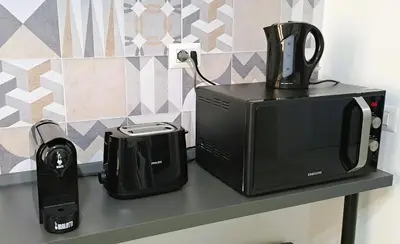 a microwave and a toaster sitting on a counter at Amores Roma Apartment in Rome