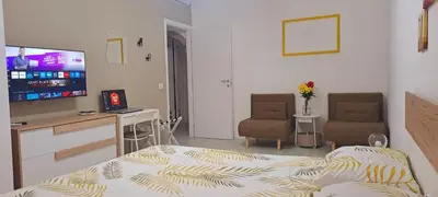 a room with a bed and a desk and a television at Amores Roma Apartment in Rome