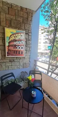 a room with two chairs and a table and a window at Amores Roma Apartment in Rome