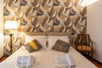 a bedroom with a bed with two towels on it at Roma Centro Storico Luxury - Piazza di Spagna in Rome