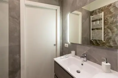 a bathroom with a sink and a mirror at Roma Centro Storico Luxury - Piazza di Spagna in Rome