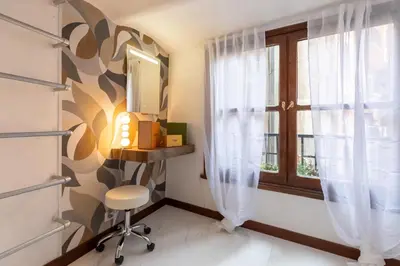 a room with a chair and a window at Roma Centro Storico Luxury - Piazza di Spagna in Rome