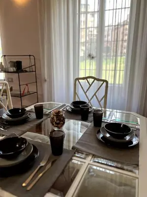 a glass table with black plates and cupcakes on it at S&M Guest Home - San Giovanni in Rome