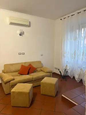 a living room with a couch and two ottoman at S&M Guest Home - San Giovanni in Rome