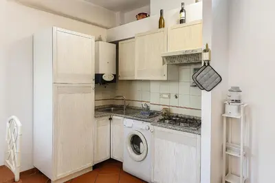 a small kitchen with a washer and dryer at S&M Guest Home - San Giovanni in Rome