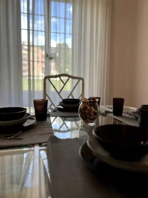a table with plates and bowls on top of it at S&M Guest Home - San Giovanni in Rome