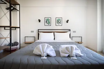 a bedroom with a bed with two white pillows at Marconi white flower house in Rome