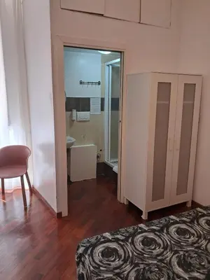 a room with a bed and a bathroom with a mirror at Domus Filiberto by Local Domus in Rome