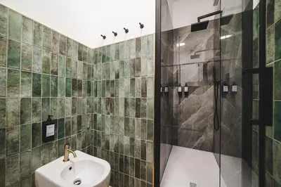 a bathroom with a sink and a shower at Tibur Domus B&B in Rome