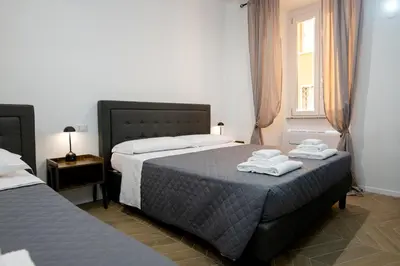 a bedroom with two beds with towels on top of them at Vatican 23 Museum Suites in Rome