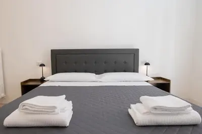 a bedroom with a bed with two towels on it at Vatican 23 Museum Suites in Rome