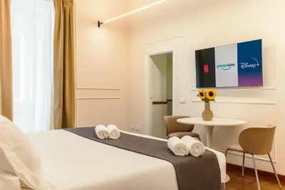a hotel room with a bed and a table at Augusto Imperatore Suite in Rome