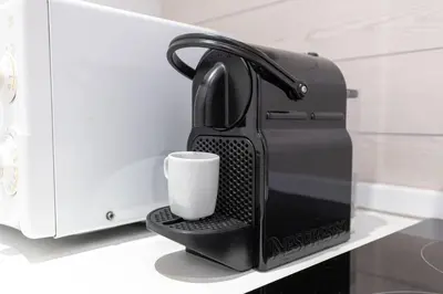 a coffee maker with a cup on a counter at Augusto Imperatore Suite in Rome